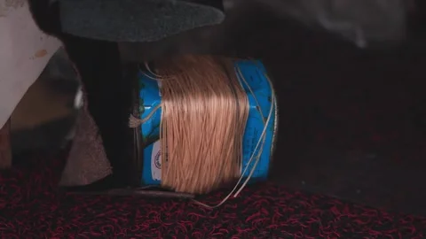 Macro slow motion of waxed thread being pulled through leather during shoe Stock Footage 333002319