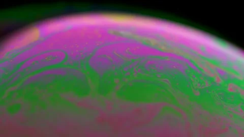 Macro soap bubble creates a colorful and psychedelic background. Rainbow colors Stock Footage 150564667