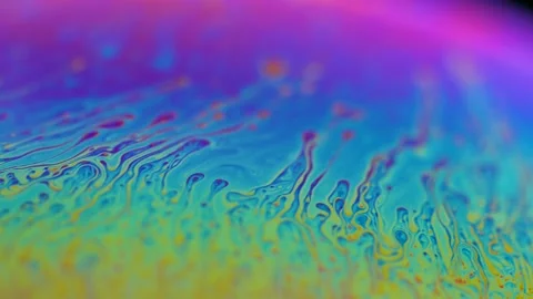 Macro soap bubble creates a colorful and psychedelic background. Rainbow colors Stock Footage 150564671