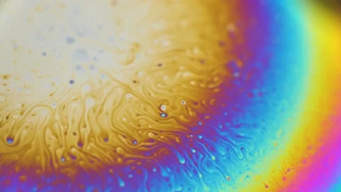 Macro soap bubble creates a colorful and psychedelic background. Rainbow colors Stock Footage 150564731