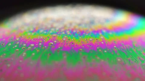Macro soap bubble creates a colorful and psychedelic background. Rainbow colors Stock Footage 150564886