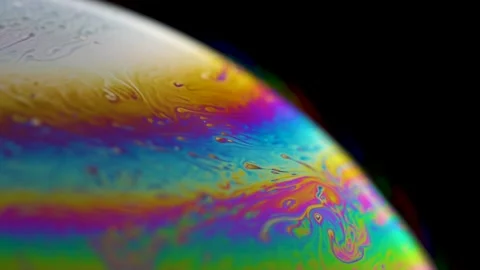 Macro soap bubble creates a colorful and psychedelic background. Rainbow colors Video stock 150565058