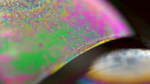 Macro soap bubble creates a colorful and psychedelic background. Rainbow colors Stock Footage 150565194