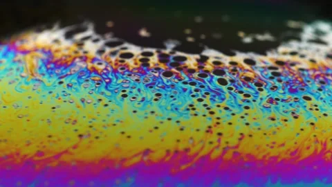 Macro soap bubble creates a colorful and psychedelic background. Rainbow colors Vídeo Stock 150565243