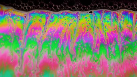 Macro soap bubble creates a colorful and psychedelic background. Rainbow colors Video stock 150565406