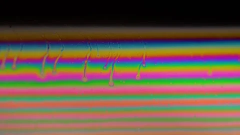 Macro soap bubble creates a colorful and psychedelic background. Rainbow colors Stock Footage 150565474