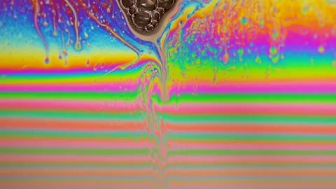 Macro soap bubble creates a colorful and psychedelic background. Rainbow colors Stock Footage 150565500