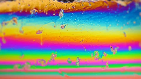 Macro soap bubble creates a colorful and psychedelic background. Rainbow colors Video stock 150565634