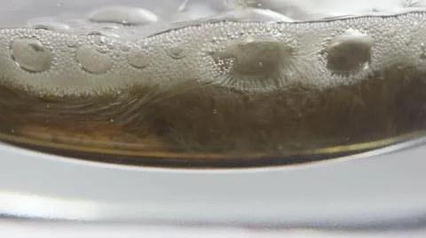 Macro soda pop bubbles poured in bottom of glass Stock Footage 68002934