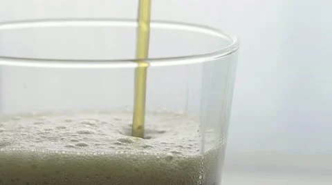 Macro soda pour with ice drop and bubbles settle Stock Footage 68002781