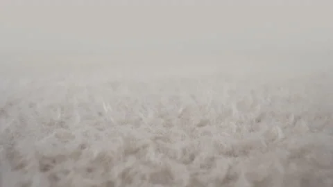 Macro soft wool fabric. Dolly beige color carpet textile texture, fur background Stock Footage 234177846