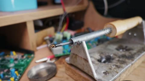 Macro Soldering Iron Stand with Tin and Rosin in Electronics Workshop 動画素材 338331625