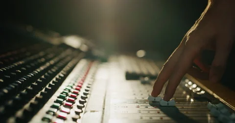 Macro of sound producer hand using music mixer in recording studio. Stock Footage 141292531