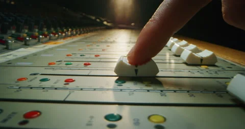 Macro of sound producer hand using music mixer in recording studio. Stock Footage 141292557