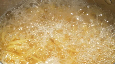 Macro of Spaghetti Pasta Cooking in Boiling Water Video stock 345770062
