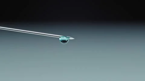 Macro of sparkling drops of water growing on a tip of a needle. They come down Stock Footage 143531834