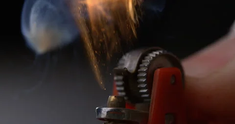 Macro of sparkling fire flame is switched on with lighter on dark background Stock Footage 268456943