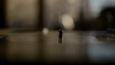 Macro of spinning vinyl record on turntable Stock Footage 129573712