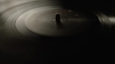 Macro of spinning vinyl record on turntable Stock Footage 129574257