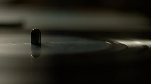 Macro of spinning vinyl record on turntable Stock Footage 129586952