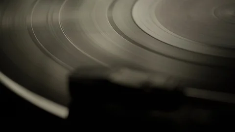 Macro of spinning vinyl record on turntable Stock Footage 129587212
