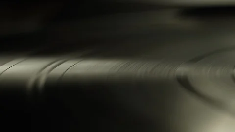 Macro of spinning vinyl record on turntable Stock Footage 129587628