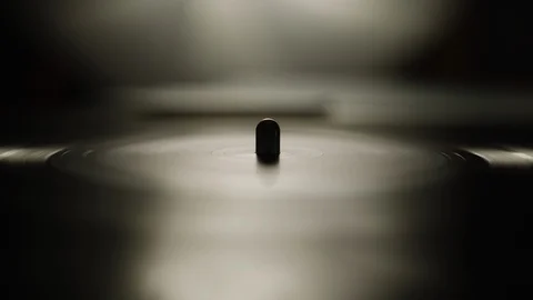 Macro of spinning vinyl record on turntable Stock Footage 129587782