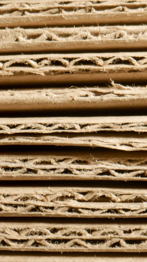 MACRO: Stack of cardboard sheets shrinks Stock Footage 341794439