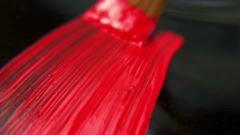 Macro. streaks of red paint on a black background. acrylic paint and paint brush Video stock 164172838