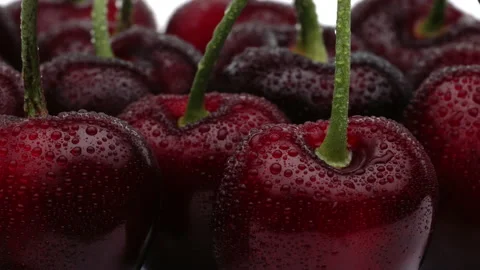 Macro of sweet cherries rotating. Isolated on white background. Stock Footage 157819204