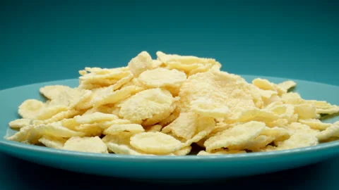 MACRO: Sweet corn flakes on a blue dish, Dolly motion Vídeo Stock 154981551