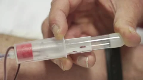 Macro of syringe while nurse draws blood Stock Footage 22038264