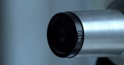 Macro taking and eye piece in and out of a microscope Stock Footage 110684736