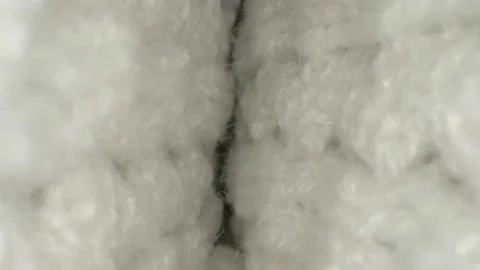 Macro. textile background. view between the folds of white wool Stock Footage 132438388