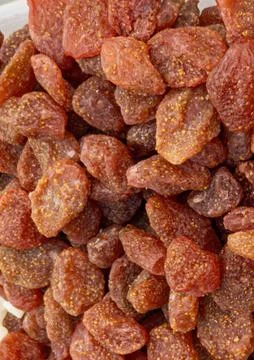 Macro texture background of sweet candied dried whole strawberries for heal.. Stock Photos