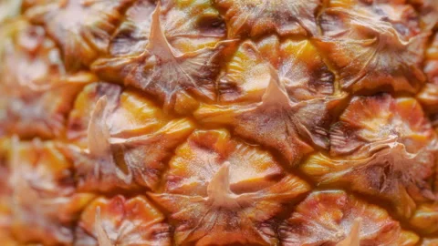 Macro texture background of tropical pineapple rotating. Slow motion Stock Footage 293625476
