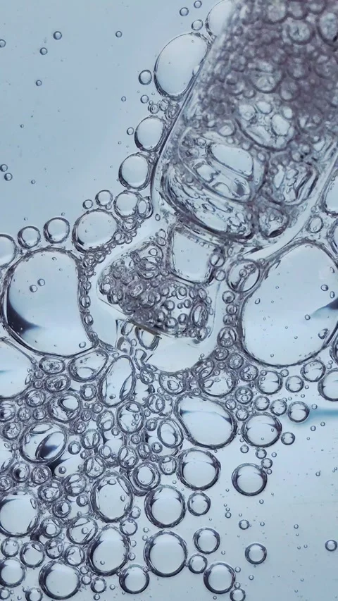 Macro texture of bubbles in blue liquid cosmetic serum. Stock Footage 329924729