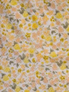 Macro texture of colorful floral patterned fabric in yellow and peach Stock Photos