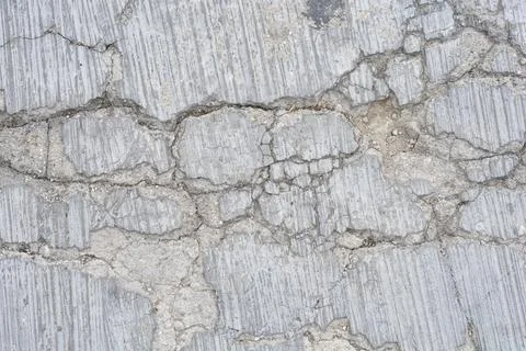 Macro texture of cracked concrete road pavement background Stock Photos
