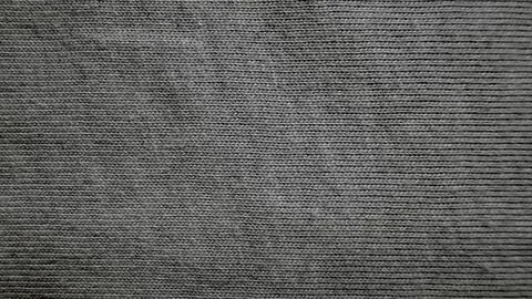 Macro texture of dark gray knitted fabric showing organic wool loops in close Stock-Fotos