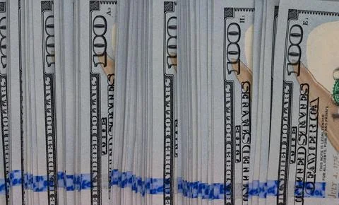 Macro texture of a dense stack of one hundred US dollar bills close-up Stock Photos