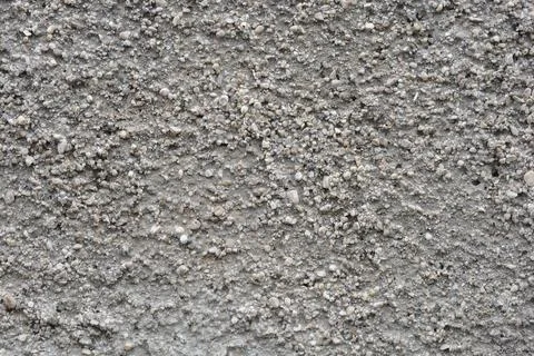Macro texture of exposed aggregate concrete wall background Stock Photos