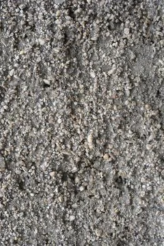 Macro texture of exposed aggregate concrete wall background Stock Photos