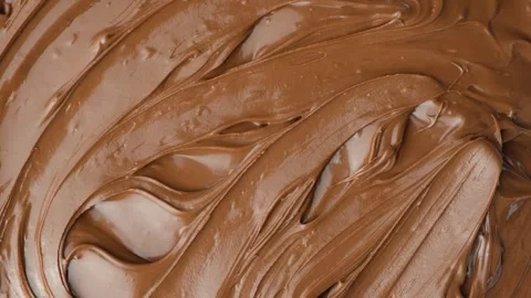 Macro texture of glossy chocolate nut cream swirling patterns Stock Footage 335877033