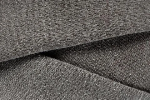 Macro texture of gray fabric with lots of pilling and damage on the surface. Stock Photos