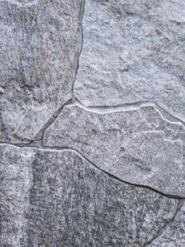 Macro texture of interlocking grey slate or stone tiles with rough surface .. Stock Photos