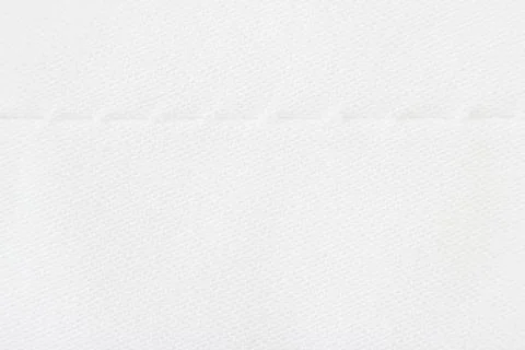 Macro texture of light beige fabric with machine seam. Foto stock