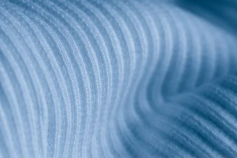 Macro texture of light blue knitted fabric with ribbed wave pattern Stock Photos
