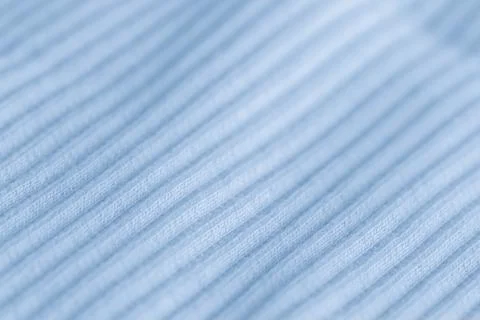 Macro texture of light blue knitted fabric with ribbed wave pattern Stock Photos
