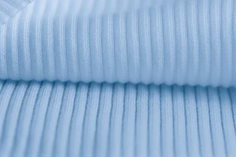 Macro texture of light blue knitted fabric with ribbed wave pattern Stock Photos